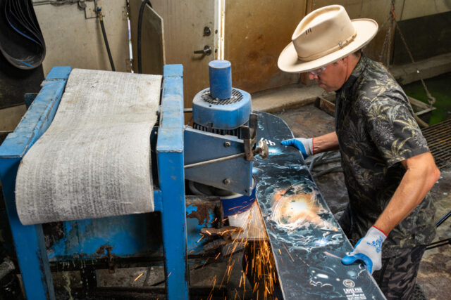 Travis steps to the grinder to finish off the Magne-Traction® edge of his T.Rice Pro.