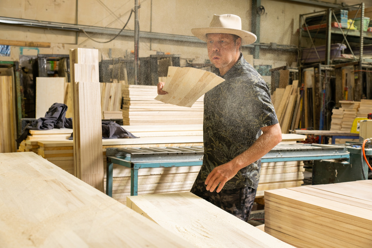 Travis in the Core Shop dusting off the beginnings of his next dream board